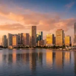 Miami’s Two Migration Stories: What the 2026 Market Report Card Means If You’re Buying Now Editorial view of the Miami skyline with residential towers and the urban core, illustrating the city's two-speed housing market