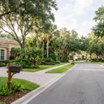 Florida Amendment 3: The Residency Clock That Changes Your Property Tax Editorial view of a Florida residential neighborhood with single-family homes, mature trees and tropical landscaping