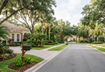Florida Amendment 3: The Residency Clock That Changes Your Property Tax Editorial view of a Florida residential neighborhood with single-family homes, mature trees and tropical landscaping